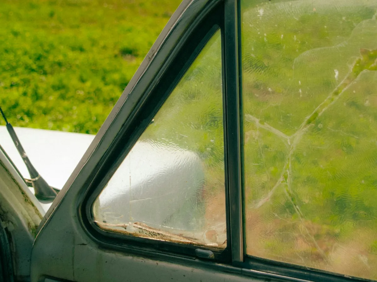 Cracked small side vent window on an older vehicle